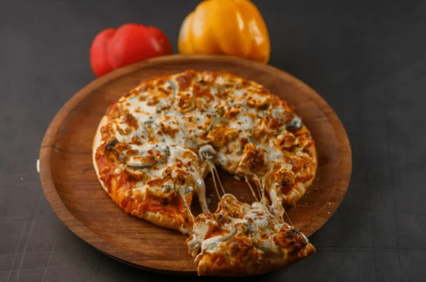 Deep-Dish Chicago Pizza with a slice apart and cheese strings.