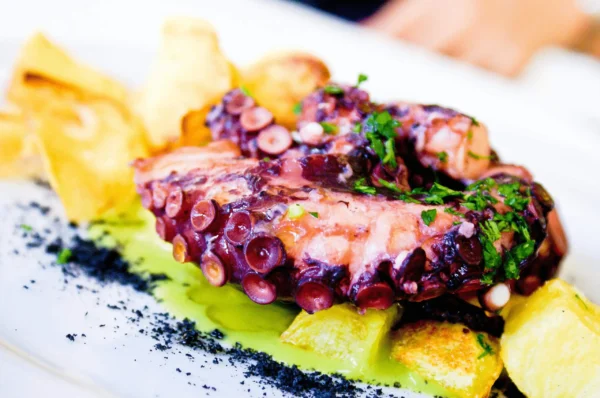 Greek Grilled Octopus on a bed of roasted potatoes.