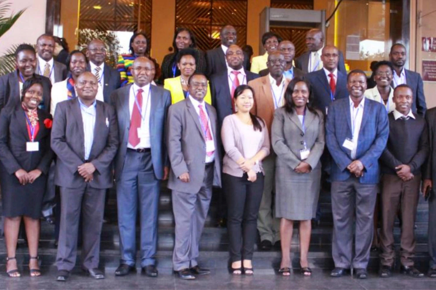 Economist Nui standing with delegates and participants from African countries at a conference in Nairobi.