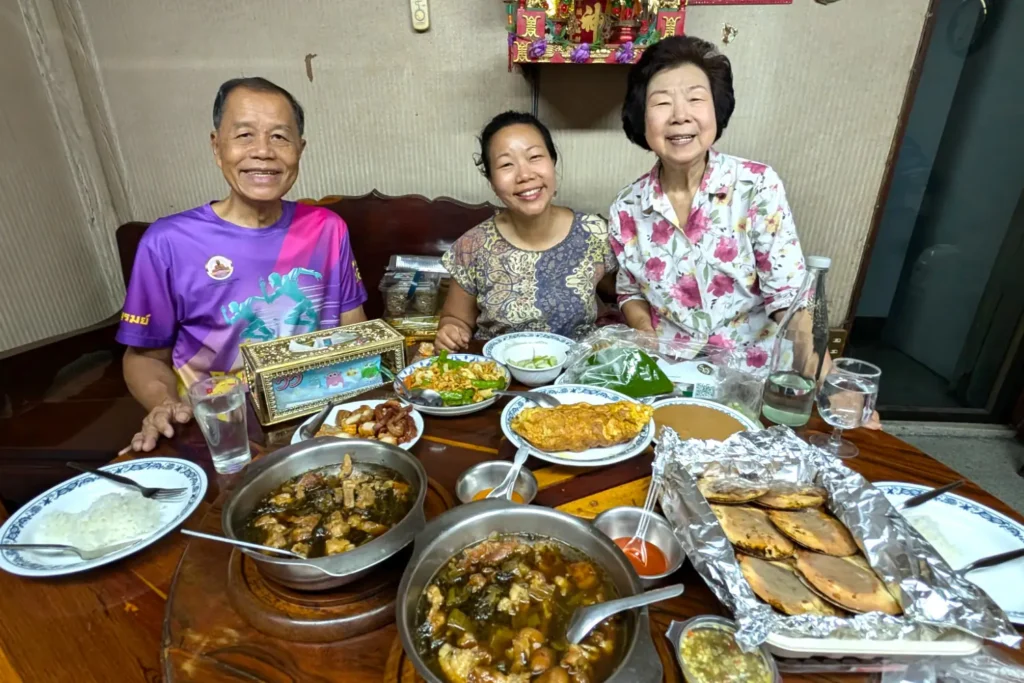 Nui and her parents enjoying a delicious and plentiful Thai meal together at home in Bangkok.