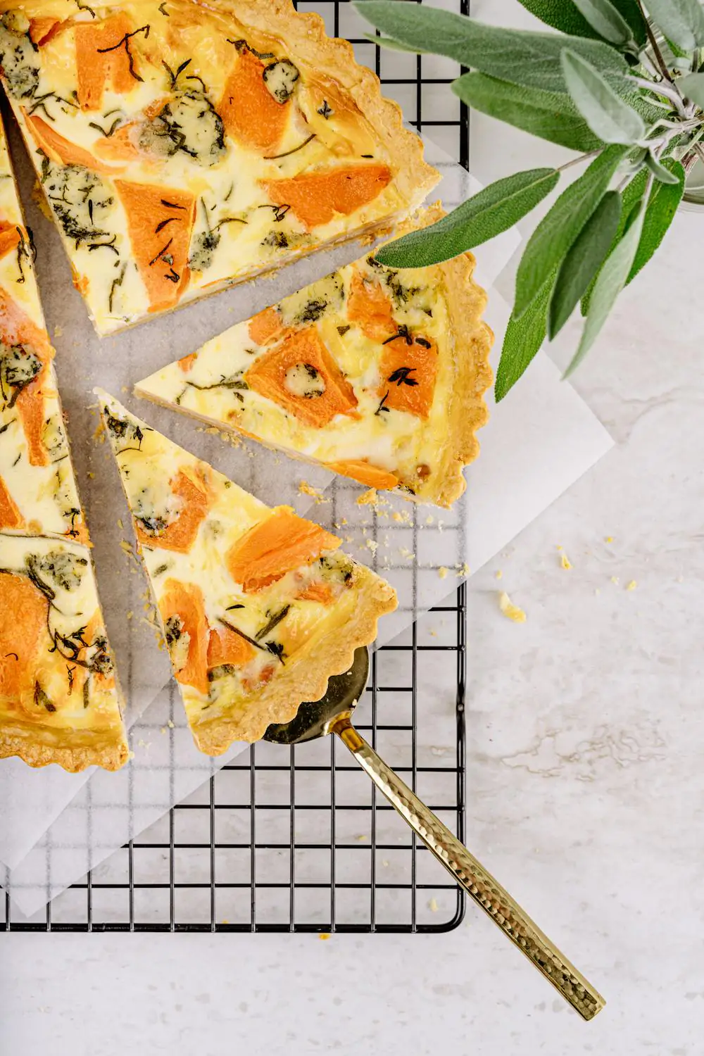 Butternut squash tart with blue cheese and sage on cooling rack.